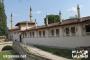 سور القصر الخارجي وتبدو فيه مآذن مسجده الكبير